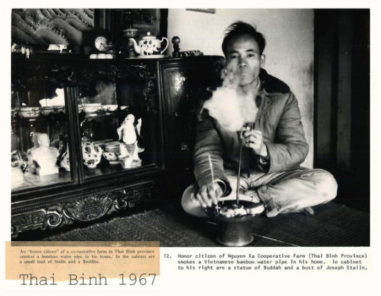 Thái Bình 1967- Xã viên tiên tiến hợp tác xã nông nghiệp xã Nguyên Xá (Vũ Thư, Thái Bình) hút thuốc lào tại nhà. Trong tủ là một tượng Phật và một tượng bán thân của Joseph Stalin. Ảnh: Lee Jonathan Lockwood/Black Star